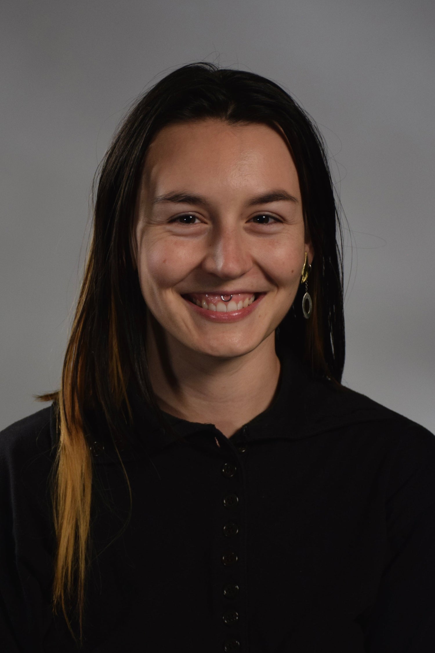 Person wearing a black shirt against a gray background with extra cool hair